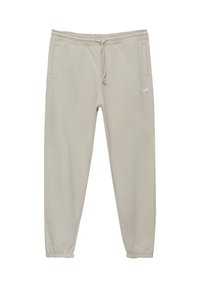 Beige Sweatpants aus weichem Stoff, mit einem elastischen Bund und einem Kordelzug, Seitentaschen und elastischen Bündchen an den Knöcheln.