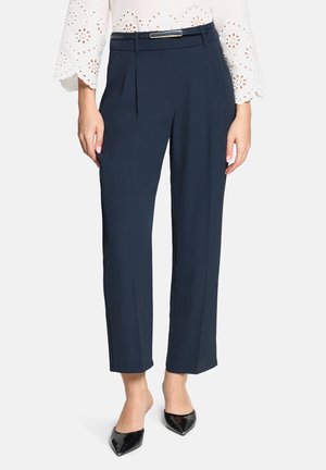 Navy trousers with a tailored fit, featuring front pleats, a silver belt buckle, and a cropped, straight-leg design.