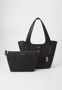 Ensemble de sacs à main en cuir noir comprenant un grand cabas avec des poignées courtes et une petite pochette zippée. Les deux présentent une finition texturée et des accents dorés.