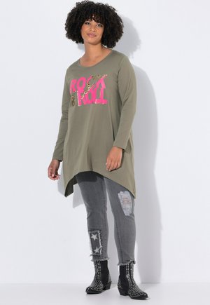 Olive green long-sleeve top with "ROCK" and "ROLL" in pink and leopard print. Paired with distressed gray jeans and studded black ankle boots.