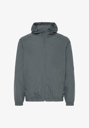 Siva lahka jakna s kapuco, z zadrgo spredaj, elastičnimi manšetami, stranskimi žepi in gladko teksturo, zasnovana za sproščeno nošenje.