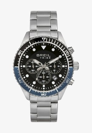 Breil Tribe-uret har en sort urskive med sølvhåndtag, chronograf underdial og et armbånd i rustfrit stål. Bezel har blå accenter.