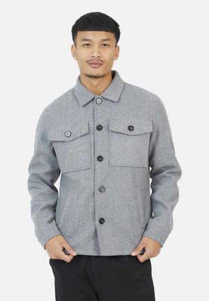 Gray wool blend jacket with a collared neck, two front flap pockets, and button closure. Features a soft texture and structured fit.