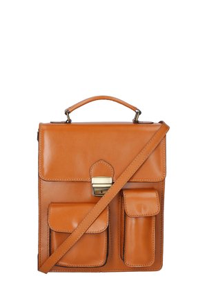 Tansatchel aus Leder mit flacher Form, einem oberen Griff, einem verstellbaren Riemen, einer frontalen Schnalle und zwei magnetischen Taschenakzenten. Glatte Textur.