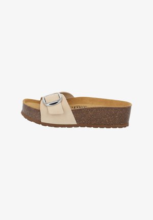 Beige slip-on sandal with a wide strap featuring a silver buckle, textured cork footbed, and a brown rubber sole.