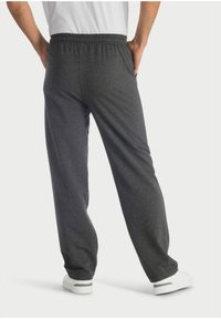Dunkelgraue Sweatpants mit elastischem Bund und Seitentaschen, aus einem weichen Stoff gefertigt, mit einer lockeren Passform und geradem Bein-Schnitt.