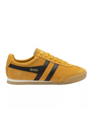 Yellow suede Gola sneaker with black side stripes, beige sole, and lace-up closure, shown from the outer side.