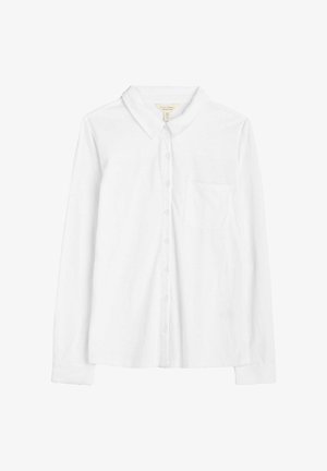 Chemise blanche à manches longues avec boutons, fabriquée en tissu doux. Elle présente un col classique, une poche poitrine et des manches à poignets classiques.