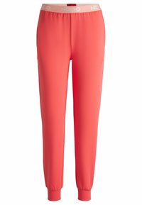 Koraalkleurige joggers van een zachte, rekbare stof met een elastische tailleband. Met cuffed enkels en een logo in een lichtere tint op de tailleband.