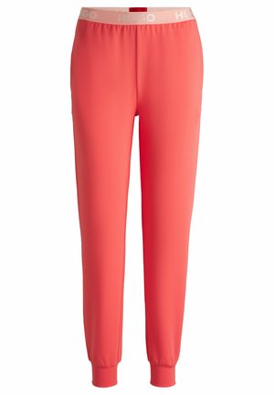 Koraalkleurige joggers van een zachte, rekbare stof met een elastische tailleband. Met cuffed enkels en een logo in een lichtere tint op de tailleband.