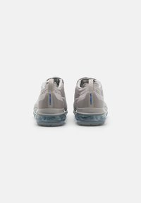 Gray mesh sneakers featuring a textured upper and a transparent air cushioning sole, with blue branding detail on the heel.