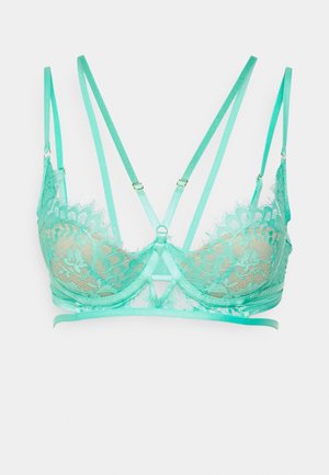 Soutien-gorge en dentelle vert menthe avec des bretelles en satin réglables, un support à armature, un motif floral décoratif et un design croisé à l'avant.