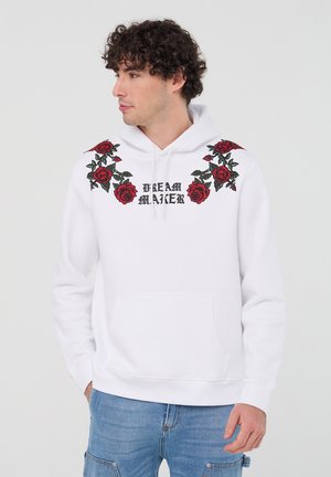 Felpa bianca con ricamo di rosa rossa e testo "DREAM MAKER" sul petto, dotata di tasca frontale e cappuccio con lacci.