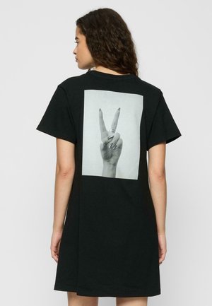 Black t-shirt dress with a relaxed fit, featuring a large graphic of a hand making a peace sign on the back. Cotton material, short sleeves.