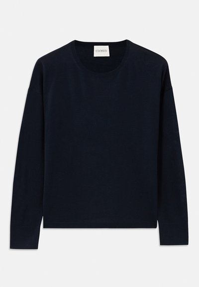 Navy long-sleeve crewneck top in soft, smooth fabric with a relaxed fit. Features ribbed cuffs and hem, label at neck.