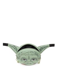 Vihreä vyölaukku, jossa on sarjakuvamainen kuvaus hahmosta, jolla on suuret ruskeat silmät ja terävät korvat. Musta hihna ja vetoketjukiinnitys.