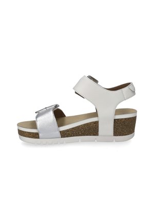 Wedge sandal with a white leather upper, silver accent strap, and a cork-textured platform. Features an adjustable buckle and rubber sole.