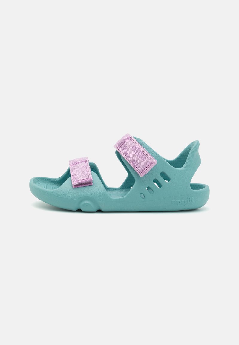 Light blue sandals made of textured rubber. Features two purple adjustable straps. Open-toe design with cut-outs for ventilation.