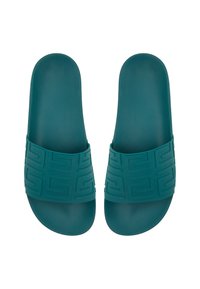 Sandales en caoutchouc teal avec une bande texturée à motif géométrique et une semelle intérieure lisse. L'élévation de la semelle à la sangle est uniforme.