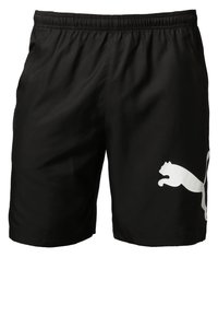 Shorts de sport noirs en tissu léger, avec une taille élastique et un grand logo Puma blanc sur la jambe gauche.