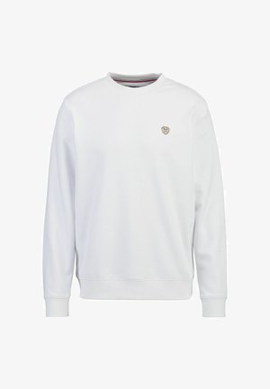 White sweatshirt with a crew neck, ribbed cuffs, and a small gold logo on the chest. Made from a soft, textured material.