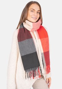 Écharpe en mélange de laine avec un motif en damier rouge, gris, noir et crème, avec des franges sur les bords.