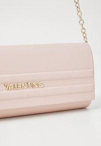 Šviesiai rožinė odinė pečių rankinė su auksiniu priedu, turinti glotnų paviršių ir glamžytą dizainą, išspausta su "Valentino" logotipu.