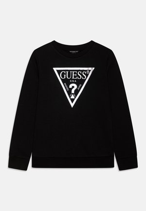 Sort langærmet sweatshirt med en sølvfarvet trekantslogo, hvor der står "GUESS U.S.A. Washed Jeans" og et stort spørgsmålstegn inde i trekanten.