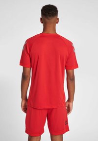 Rode sportshirt en short set, gemaakt van lichtgewicht stof. Kenmerkt zich door een ronde hals, korte mouwen en een gestructureerd oppervlak.