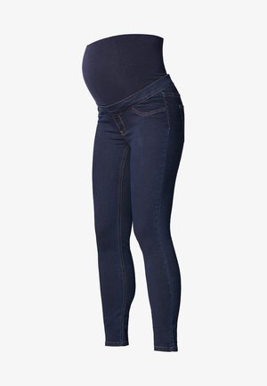 Jean slim maternité bleu foncé avec une taille haute élastique conçue pour s'adapter à un ventre de femme enceinte.