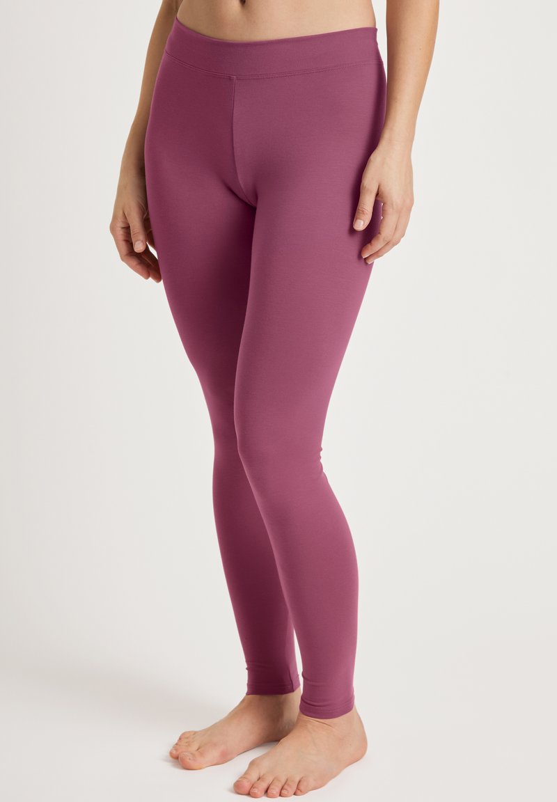 Paarse leggings gemaakt van gladde stof, met een hoge tailleband en een slim fit, die de benen van taille tot enkel omarmen, zonder zichtbare patronen.