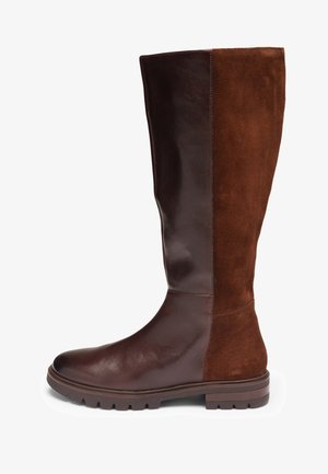 Knee-high boot with dark brown leather front and heel with contrasting lighter brown suede back, ridged sole, and rounded toe.
