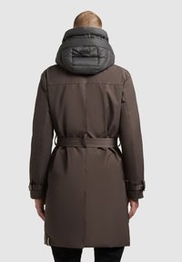 Brown parka coat with a detachable gray puffer hood, belted waist, and adjustable sleeve cuffs. Smooth texture and tailored fit.