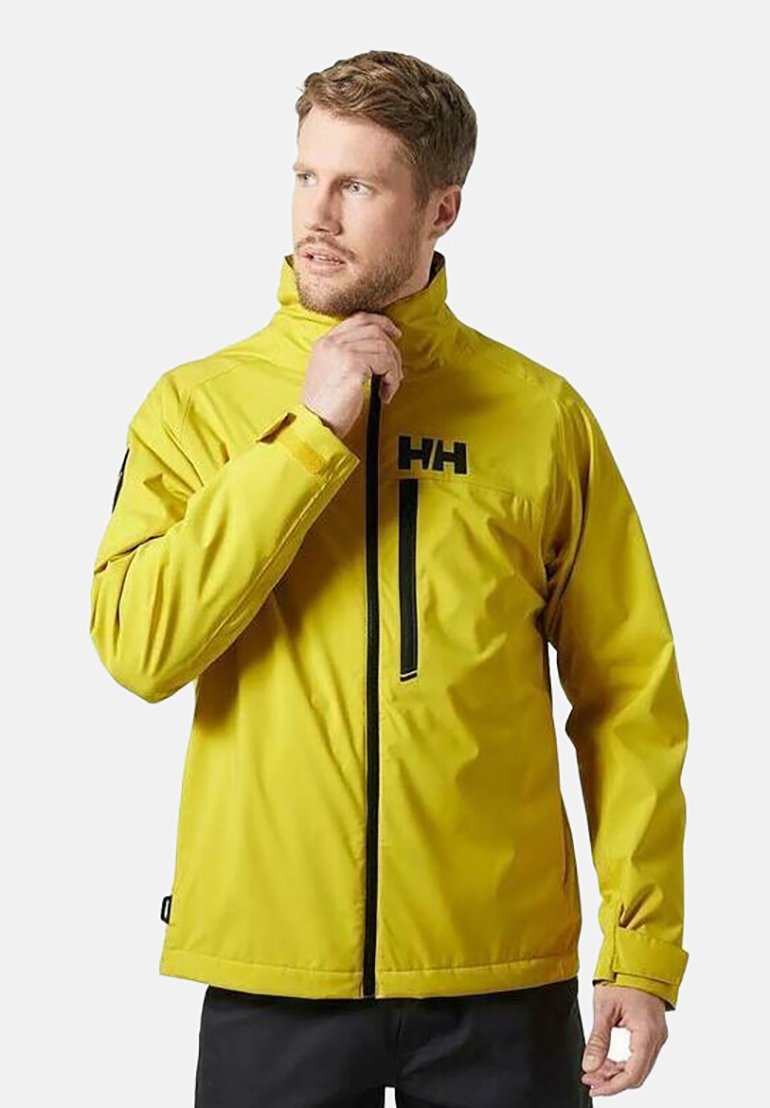 Giacca impermeabile gialla con zip nere e logo. Caratterizzata da un colletto alto e polsini regolabili. Realizzata in materiale leggero e resistente.
