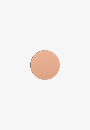 Solid round beige powder compact on a white background, likely makeup or cosmetic product.