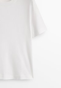 T-shirt en coton blanc uni à manches courtes avec col rond, présenté de face sur fond blanc.