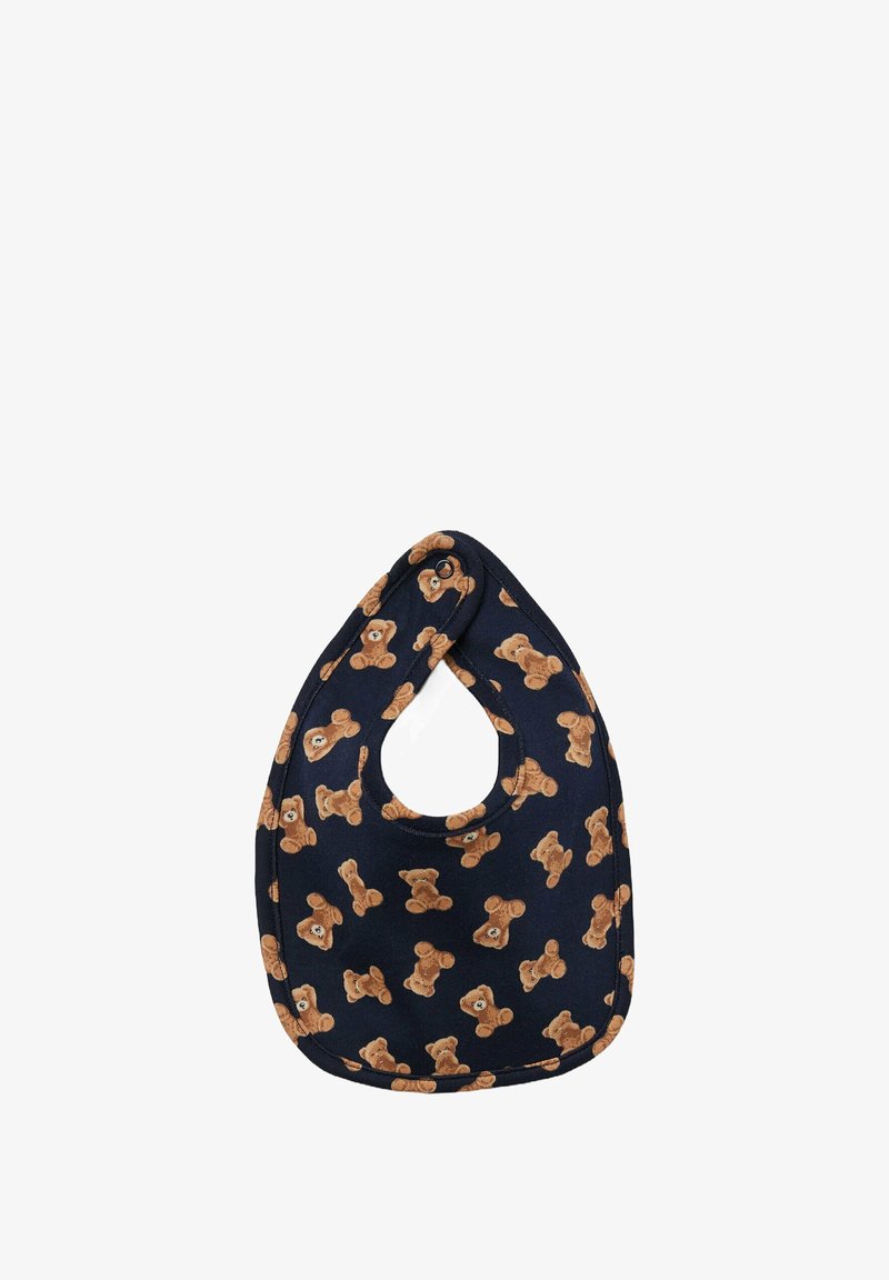 Námořnický modrý bryndák vyrobený z bavlny s opakujícím se vzorem medvídků. Zaoblený vrchní okraj s kulatým otvorem pro snadné navlékání.