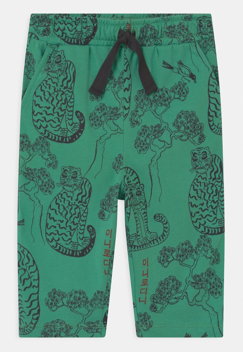 Pantalon vert pour enfants avec illustrations noires de tigres, branches d'arbres, petits oiseaux et cordon noir à l'avant.