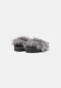 Gray faux fur slide sandals with a chunky black sole. Features a wide furry band across the top for comfort and added texture.