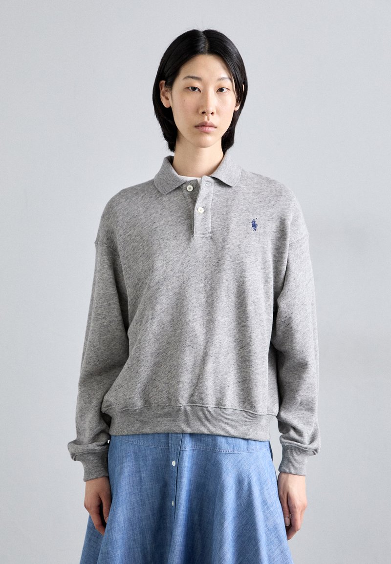 Gray sweatshirt with a polo collar, featuring a small blue logo. The fabric is soft, with ribbed cuffs and hem for a comfortable fit.