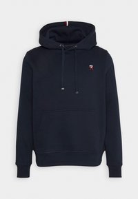 Marineblauwe hoodie van een katoenmix, voorzien van een voorvak, verstelbare trekkoorden en een klein logo. Zachte textuur met geribbelde manchetten.