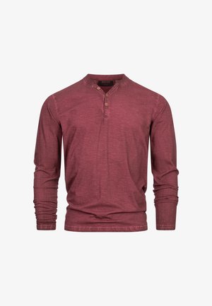Weinrot langärmliges Hemd aus strukturiertem Stoff. Hat einen Henley-Ausschnitt mit drei Knöpfen und eine lockere Passform. Einfaches Design ohne Muster.