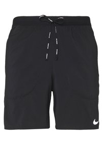 Pantalones cortos de deporte negros con cintura ajustable, bolsillos laterales y un logo blanco de Nike en la parte inferior derecha. Textura suave.