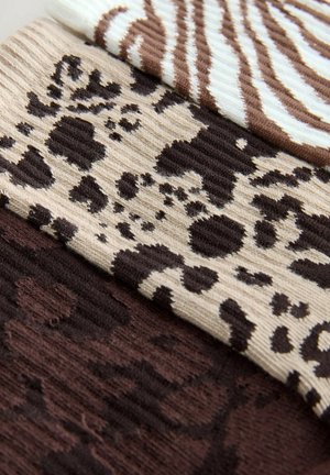 Three fabric samples: a light blue and brown striped, a tan with dark brown spots, and a solid dark brown, all in textured ribbed material.