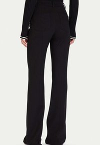 Czarne spodnie z rozszerzanymi nogawkami o gładkiej fakturze, z dwoma tylnymi kieszeniami, wysokim stanem i kontrastującymi białymi akcentami na mankietach.