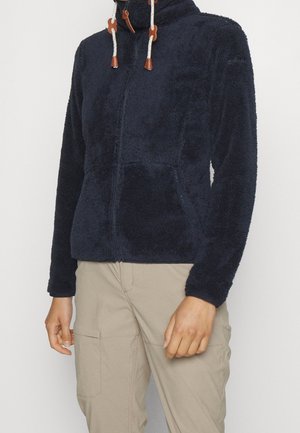 Marineblauwe fleece jas met hoge kraag, ritssluiting aan de voorkant en twee zijzakken. Kenmerkt zich door contrasterende leren accenten en een zachte, gestructureerde stof.
