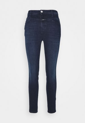 Mørkeblå skinny jeans med høj talje, knaplukning og forlommer, vist mod en hvid baggrund.