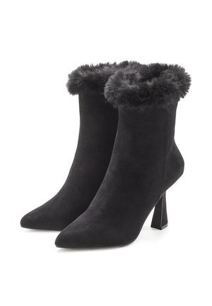 Black suede ankle boots with a pointed toe and a fur trim at the top, featuring a sturdy block heel for added support.