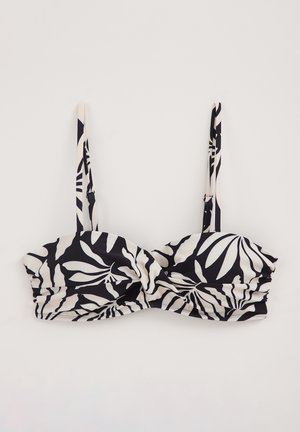 Bikini-Oberteil mit schwarz-weißem Blattdruck, gepolsterten Cups, geraffter Textur und verstellbaren Trägern. Das Material wirkt glatt und dehnbar.