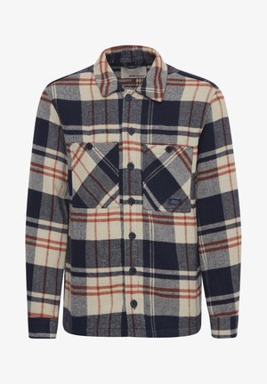 Camisa de franela de cuadros en azul marino, crema y óxido, con cierre de botones en la parte delantera, dos bolsillos en el pecho y un cuello de textura suave.